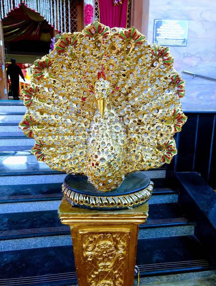 Golden peacock artwork at the entrance